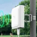 Pole-mounted TP-Link EAP650 D120-Outdoor Access Point emitting green signal waves in a park setting.
