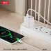 Lifestyle view of the XO L147 EU 20W Fast Charger Adapter plugged into a power strip while charging a smartphone wirelessly