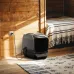 EcoFlow WAVE 3 Hot & Cool Portable AC placed beside a bed in a wooden room, plugged into a wall outlet.