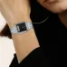Close-up wrist view of Casio AQ-230A-1DMQ Watch with analog hands and digital display beside face and earring.
