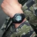 Wrist view of Casio F-200W-1ADF Watch with black strap and digital display worn with camouflage jacket outdoors.