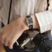 Wrist view of Casio LTP-V007L-1BUDF Ladies Watch with black dial worn while holding Nikon film camera.