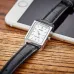 Top view of Casio LTP-V007L-7E1UDF Ladies Watch with white dial and black leather strap placed on smartphone.