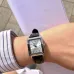 Wrist view of Casio LTP-V007L-7E1UDF Ladies Watch with silver dial worn with striped shirt cuff visible.