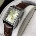 Display view of Casio LTP-V007L-9EUDF Ladies Watch with silver dial, gold hands, and brown strap on cushion.