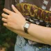 Wrist view of Casio LTP-V007L-9EUDF Ladies Watch with white dial worn casually with Guns N’ Roses T-shirt.