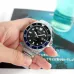 Casio MDV-107D-1A2VDF Enticer Chain Watch hand-held close-up stainless steel band black dial blue bezel detail