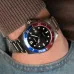 Close-up wrist view of Casio MDV-107D-1A3VDF Chain Watch with black dial and red-blue bezel worn with knit sleeve.