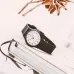 Display view of Casio MQ-24-7B3LDF Unisex Watch with white dial and black strap resting on closed book surface.