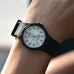 Wrist view of Casio MQ-24-7B3LDF Unisex Watch with white dial, black numerals, and resin strap worn casually.