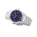 Lifestyle wrist view of Casio MTP-1215A-2ADF Analog Watch with silver band styled with striped shirt and jeans.