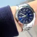 Wrist view of Casio MTP-1215A-2ADF Analog Watch with silver band and blue dial showing date window.