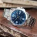 Angled display view of the Casio MTP-1314D-2AVDF Analog Watch with a blue dial resting on a wooden table.