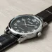 Top view of Casio MTP-V001L-1BUDF Watch placed on wooden surface with black dial and silver hands.
