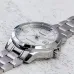 Top view of Casio MTP-V004D-7B2UDF Watch resting on textured surface with silver dial and polished metal finish.