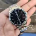 Handheld view of Casio MTP-V005D-1BUDF Analog Watch with polished silver case and black dial marked 12 and 6.