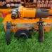 Front flat lay view of the INGCO AG750282 100mm 750W Angle Grinder with its accessories on a green mat.