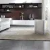 Living room setup with DeLonghi AC230 Air Purifier placed on rug near sofa