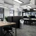 Office view of Dyson BP06 Air Purifier placed centrally among desks, emphasizing clean air in shared workspace.