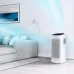 Living room view of Samsung AX60R5080WD/EU Air Purifier showing blue airflow graphics beside sofa and lamp.