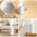 Xiaomi Smart Humidifier 2 emitting mist on table, floor, and shown with smartphone app for smart control.