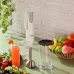 Kitchen counter view of the Panasonic MX‑GS1 Hand Blender standing upright beside fresh ingredients and a glass jar.