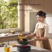 Lifestyle view of Xiaomi Mijia S1 Induction Cooker used by woman stir-frying vegetables in modern kitchen with 2200W firepower.