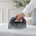 In‑use view of the Panasonic NI‑WL55 Cordless Steam Iron gliding smoothly over fabric on an ironing board.