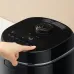 Close‑up lid view of the Panasonic SR‑DM104 1L Rice Cooker showing a finger pressing the top control button.