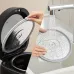 Cleaning view of the Panasonic SR‑DM104 1L Rice Cooker showing the removable lid being washed under running water.