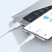 Close-up of the white BWOO BO-X286V Micro-USB cable connecting a smartphone to a laptop's USB-A port.