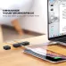 UGREEN LP208 cable organizer on a wooden desk, holding two charging cables connected to a laptop and a phone.