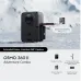 Front view of DJI Osmo 360 II action camera on snow showing side battery compartment, extra batteries, and case.