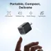 Detailed shot of the compact, black Anker Nano 45W charger with a foldable plug, held delicately between fingers.