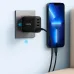 Wall view of Anker Zolo 70W Charger Adapter plugged in with braided cable charging smartphone beside outlet.