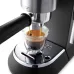 Close-up of DeLonghi EC685 Dedica Style Coffee Maker brewing espresso with rich crema into a glass cup.