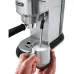 Side view of DeLonghi EC885.M Dedica Arte Coffee Machine frothing milk in pitcher using steam wand for cappuccino.