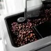 Top view of Delonghi ECAM45-760-W Eletta Coffee Machine grinder hopper filled with beans and adjustable grind dial.