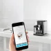 Lifestyle view of Delonghi EPAM960-75-GLM Maestosa Coffee Machine controlled via smartphone app for cappuccino customization.