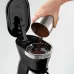 Close-up of DeLonghi ICM12011 Active Line Coffee Maker with lid open as ground coffee is poured into filter basket.
