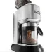Close-up of DeLonghi KG521 Dedica coffee grinder dispensing freshly ground coffee into its container.