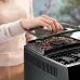 DeLonghi Magnifica S coffee machine with bean hopper and fresh coffee beans