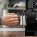 DeLonghi Magnifica S coffee machine steaming milk with stainless steel milk frothing jug
