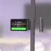 Wall-mounted Logitech Tap Scheduler showing digital meeting room display with availability status.