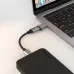 Close-up of the black ONTEN OTN-5311T adapter's USB-A plug inserted into a laptop.