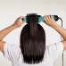 Usage view of Revlon One-Step Hair Dryer And Volumizer Teal Edition showing hands styling long hair with brush dryer