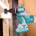 Action shot of TOTAL TIDLI20558 Drill Machine boring a hole in wood with hole saw bit and visible sawdust spray.