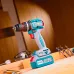 Workbench view of TOTAL TIDLI20868 Drill Machine placed with drill bits, safety glasses, and tools in workshop setting.