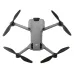 A high-angle view of the DJI Mini 5 Pro Fly More Combo drone, with its arms unfolded and propellers visible.