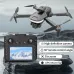 High-angle view of the U6 Toy Drone hovering in the air beside its remote controller resting on a rock.